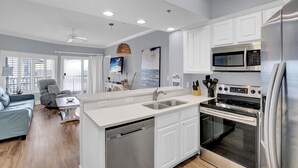 A modern kitchen with white cabinetry, stainless steel appliances, and a dishwasher. - 🐬Outdoor Pool-Stunning Gulf Views-Palm Beach D52🐬 (Orange Beach)