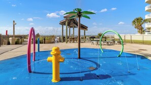 A water play area with a yellow fire hydrant, a gazebo, and a palm tree decoration. - 🌞Beachfront Bliss | Gulf Views | Amazing Amenities | Phoenix I 1097🌞 (Orange Beach)