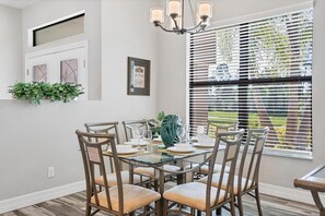 Enjoy meals in this dining area with a glass-top table and six comfortable chairs.