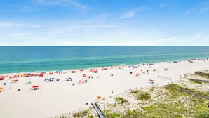 A beach with white sand, clear blue water, and a wooden boardwalk. - 🌊Shoalwater 903 | Gulf Front | Breathtaking Views🌊 (Orange Beach)
