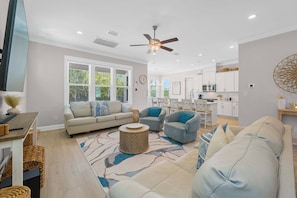 A modern living room with a sofa, armchairs, a coffee table, and a dining area with chairs. - ⭐Fabulous Amenities | Close to Beach | Summer Salt 24181⭐ (Orange Beach)