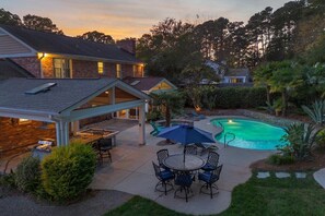 A residential property with a swimming pool, patio furniture, and a covered outdoor seating area. - 4BR, Best Location, Pool, Hot tub, Game Room (raleigh)