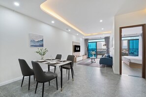 Luxury Apartment, City View | Living area | 55-inch flat-screen TV with digital channels, Netflix, books - Cosmos Hotel Apartment (Hanoi)
