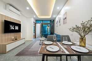 Family Room, City View | Living area | 55-inch flat-screen TV with digital channels, Netflix, books - Cosmos Hotel Apartment (Hanoi)