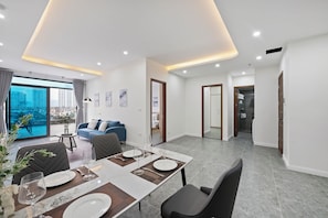 Luxury Apartment, City View | Living area | 55-inch flat-screen TV with digital channels, Netflix, books - Cosmos Hotel Apartment (Hanoi)