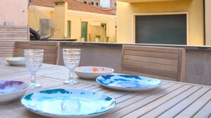A table set with plates and glasses on an outdoor patio.