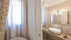 A bathroom with a toilet, sink, and mirror. - Villa Adriatica Near Ostuni Puglia (Ostuni)