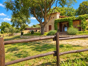 A stone building with a wooden fence in the foreground.