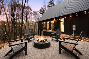 A modern building with a fire pit surrounded by Adirondack chairs. - Stonehaven | Hocking Hills, Modern, Views, Hot Tub (Rockbridge)