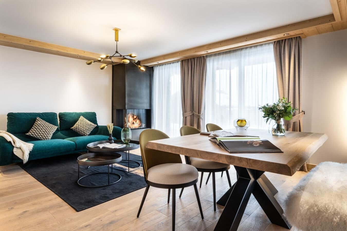 Uma sala de estar moderna com sofá, mesa de centro, mesa de jantar, cadeiras e lareira.