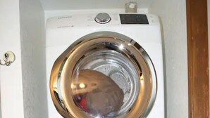 A stacked washer and dryer unit in a laundry room. - Soothing 2-bdrm condo near beach with WiFi and Fireplace (Ocean Shores)