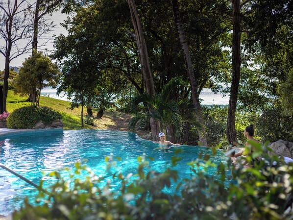 Outdoor pool, pool umbrellas, pool loungers - Reunion Wellness Resort & Retreats (Tempate)