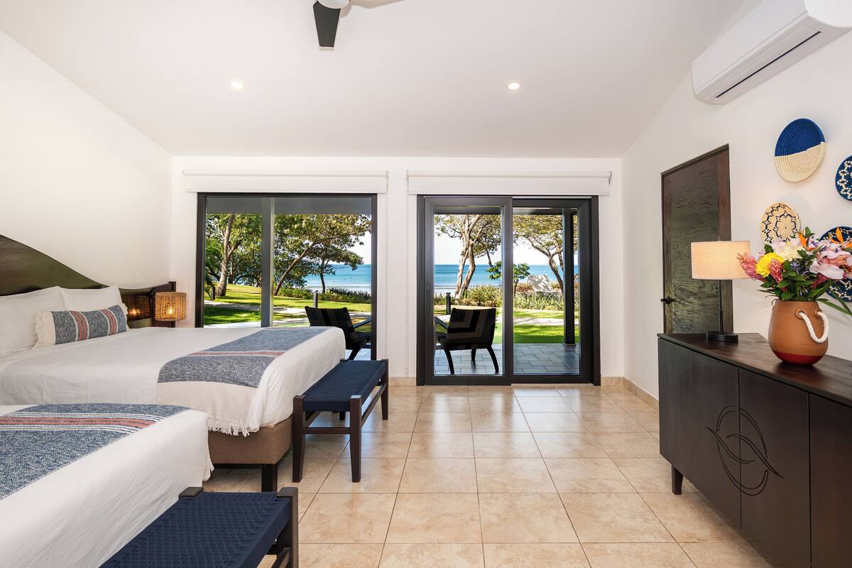 Double Room, 2 Queen Beds, Patio, Ocean View | In-room safe, WiFi (free), bed sheets