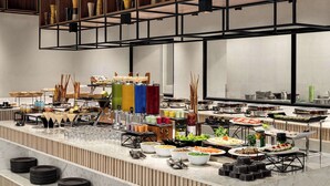 A buffet setup with various food items and beverages. - Ramada Encore By Wyndham Bhiwadi Phool Bagh Chowk (Tijara)