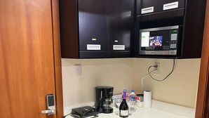 A compact kitchenette with a microwave, coffee maker, and a small refrigerator. - Fully furnished two-bedroom apartment (Cuenca)