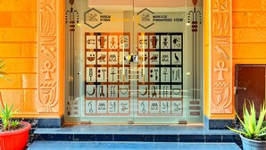 A building entrance with the word "EGYPTI" above the door, featuring Egyptian hieroglyphs and symbols. - Mirage Pyramids View  (Giza)