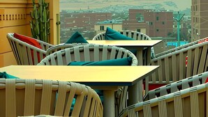 A dining area with a view of the pyramids at sunset. - Mirage Pyramids View  (Giza)