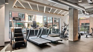 A gym with treadmills, a stair climber, and stationary bikes. - Landing Apartments Durham (Durham)