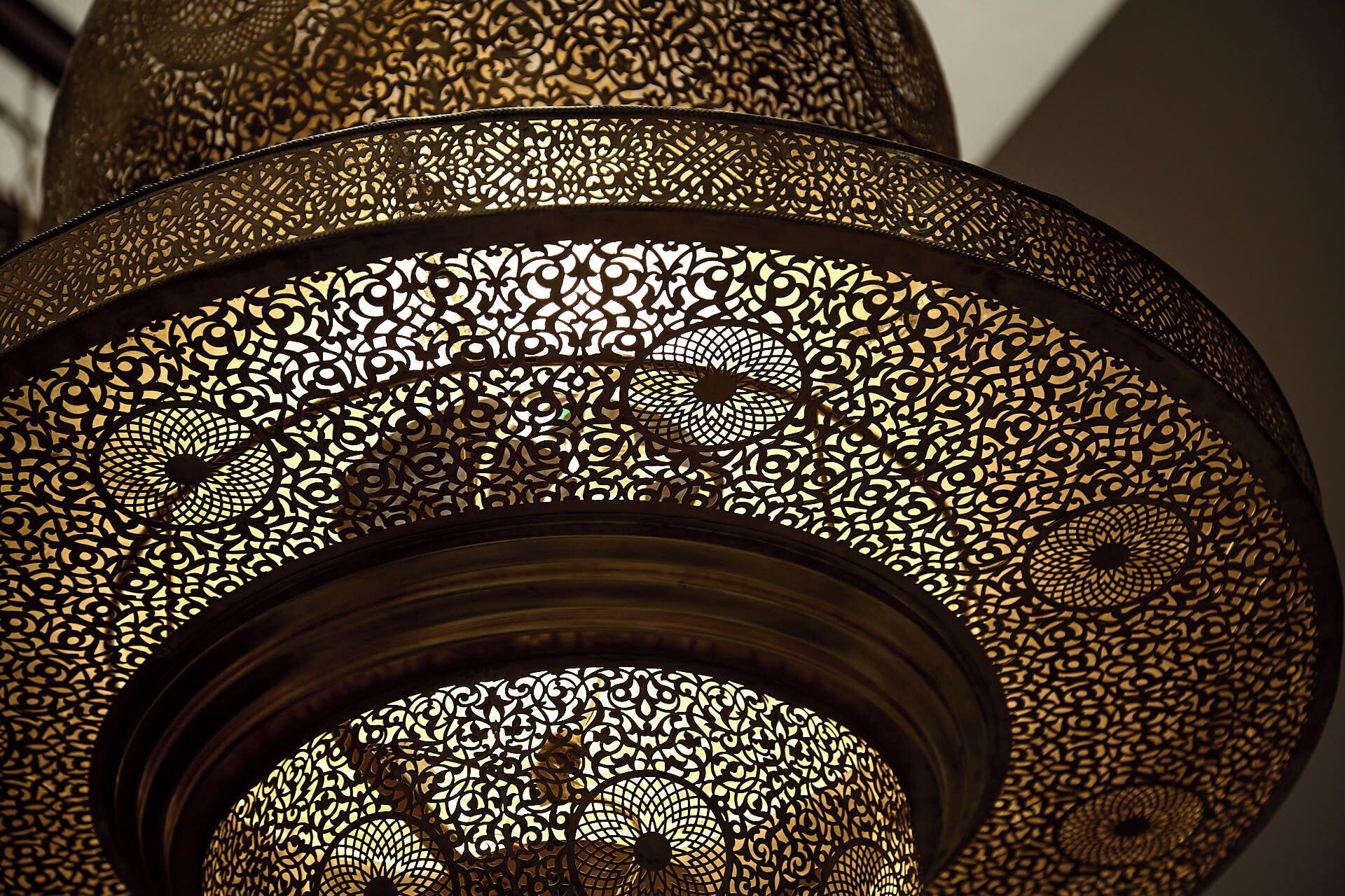 A close-up of a decorative metal lamp with intricate patterns.