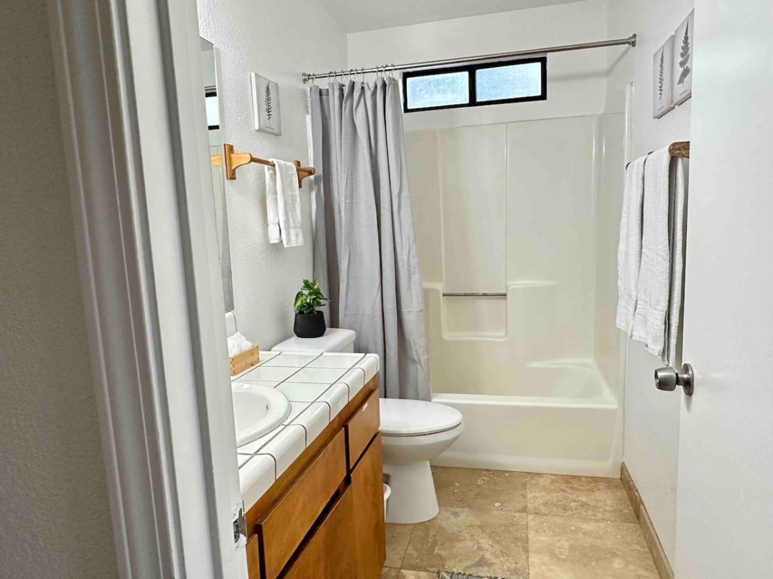 A bathroom with a toilet, sink, and bathtub.