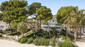 A coastal property with a beach, a pool, and a large house with multiple balconies. - Casa Ketilla, front line apartment (Alcúdia)