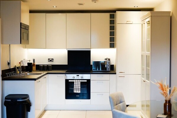 A modern kitchen with integrated appliances, a dishwasher, and a built-in oven.