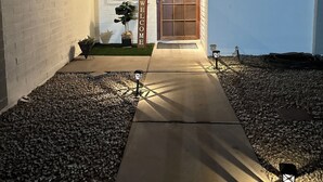 A modern house with a concrete pathway leading to a wooden door with a glass panel. - A Getaway Home with a pool table, table tennis & a Pool. (Phoenix)
