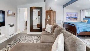 A modern living room with a sofa, a TV, and a wooden cabinet.