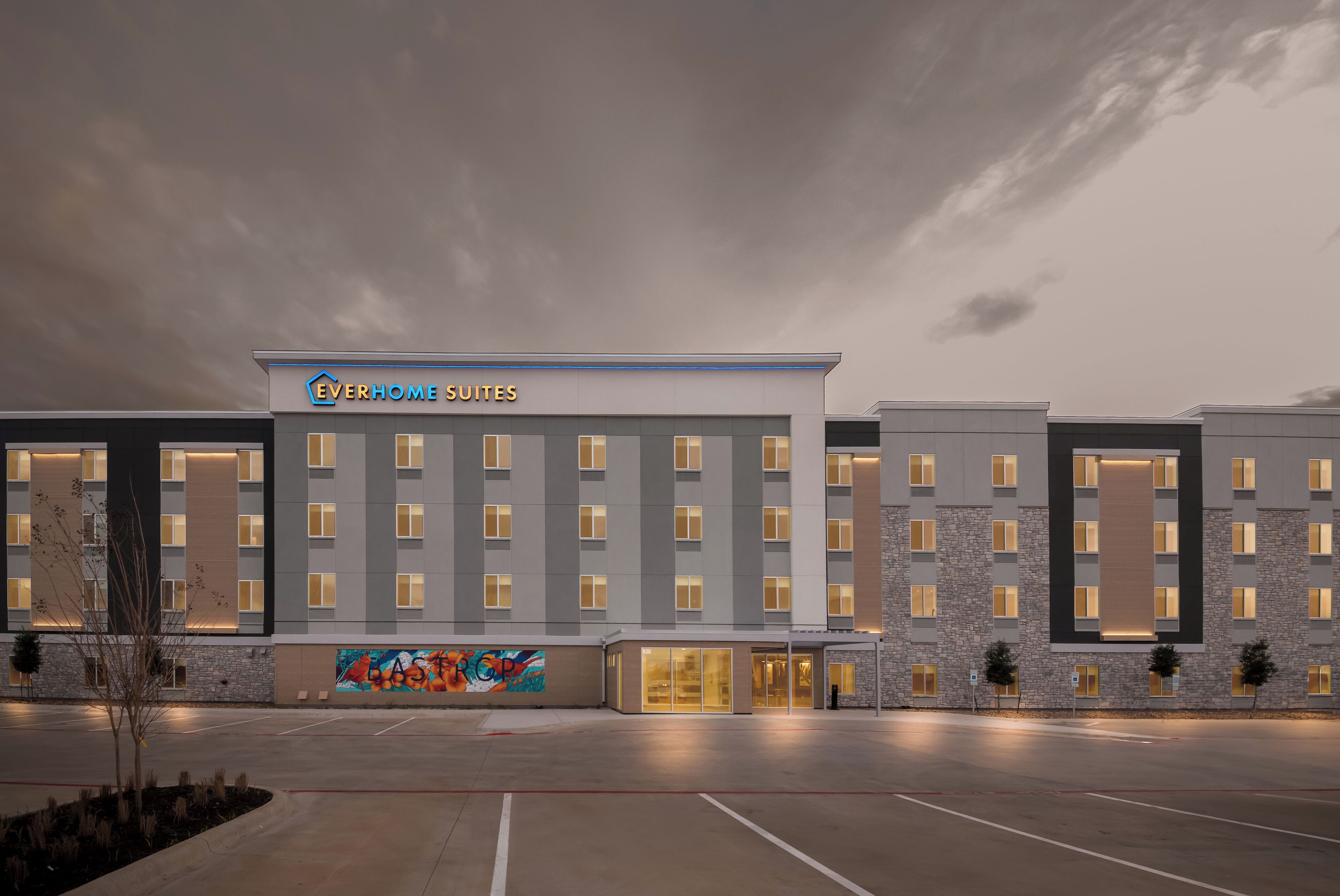 A hotel with a modern facade, multiple floors, and a well-lit entrance.