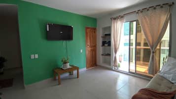Deluxe Suite, Balcony, Beach View | Living area | 43-inch TV with digital channels