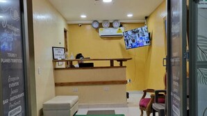 A reception area with a check-in/check-out counter, a television mounted on the wall, and a ceiling fan. - Dreimar hotel boutique - La Boquilla Cartagena. (Cartagena)