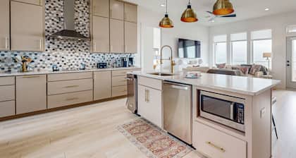 Exquisite beachfront home w/ heated pool, ample outdoor seating, & beach access