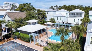 A residential area with a swimming pool, houses, and a covered patio area. - 30A Ocean Pearl by Avantstay Newly Built Pool Access + Golf Cart Walk to Dune Allen Beach (Santa Rosa Beach)