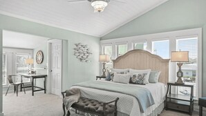 A bedroom with a large bed, a desk, and a chair. There is a ceiling fan and a window with blinds. - Walk to Blue Mountain Beach, Private Pool, Hot Tub 30A Sea-renity by Avantstay (Santa Rosa Beach)