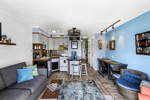 A compact living space with a kitchenette, a dining area, and a seating area. - Oceanfront Condo~Heated Pool~Walk to Beach~Views (Galveston)