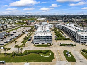 A large, modern hotel complex with multiple buildings, a central courtyard, and a parking lot.