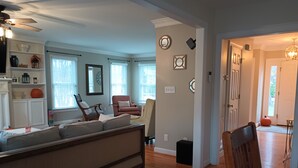 A spacious living room with a large sectional sofa, a fireplace, and a dining area with a table and chairs. - Large Beautiful quality home in a quiet subdivision.  (Lynchburg)