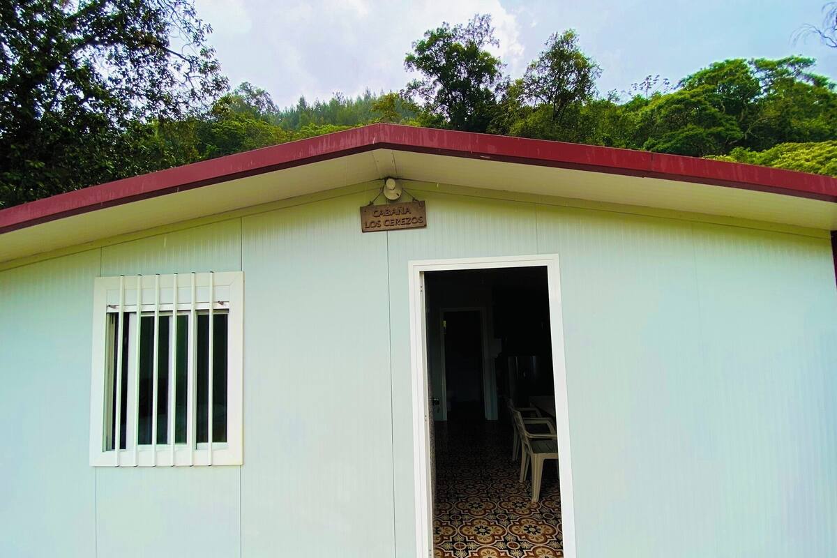 A small building with a sign reading "CABANA LOS CEREZOS".
