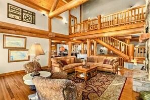 Great Room - Leather sofas and accent chairs gather beneath the log beam ceiling and open loft with log railing. - Lakefront Boat Dock, Kayaks & Amazing Sunsets (Mineral)