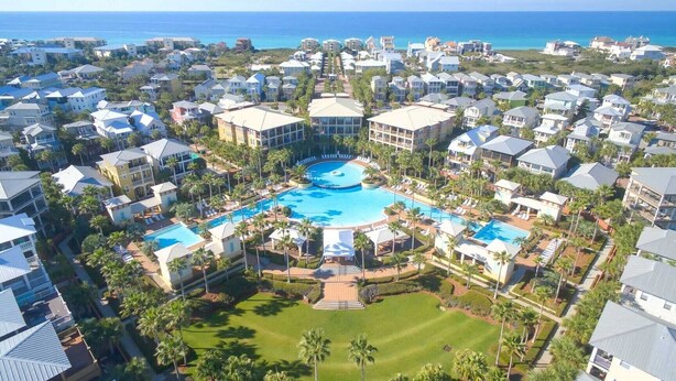 A resort with a central swimming pool surrounded by villas and a golf course. - Steps to Beach Pool, Bikes & Game Room Seacrest 5BR (Panama City Beach)
