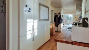 A kitchen with a wooden floor, white cabinets, and a window. - Cozy home in Kållekärr with WiFi (Kållekärr)