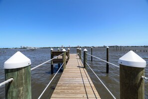 A wooden pier extending into calm waters with a clear sky above. - Minutes to Beach Pool Intracoastal Free Kayaks/Bikes, Intracoastal Sea Life Retreat (Holly Hill)