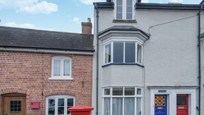 A two-story residential building with a brick facade and a white-painted upper section. - 3 bedroom accommodation in Ludlow (Ludlow)