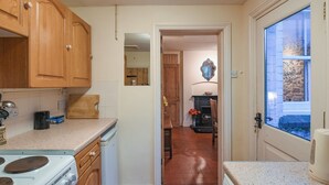 A kitchen with wooden cabinets, a stove, and a countertop. - 3 bedroom accommodation in Ludlow (Ludlow)