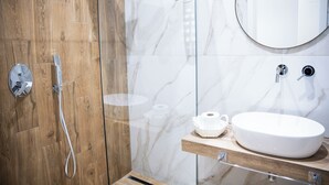A modern bathroom with a wooden shower enclosure, a marble vanity, and a round mirror. - Dimora Diaz B&B (Naples)