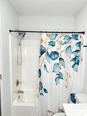 Shower, hair dryer, towels, toilet paper