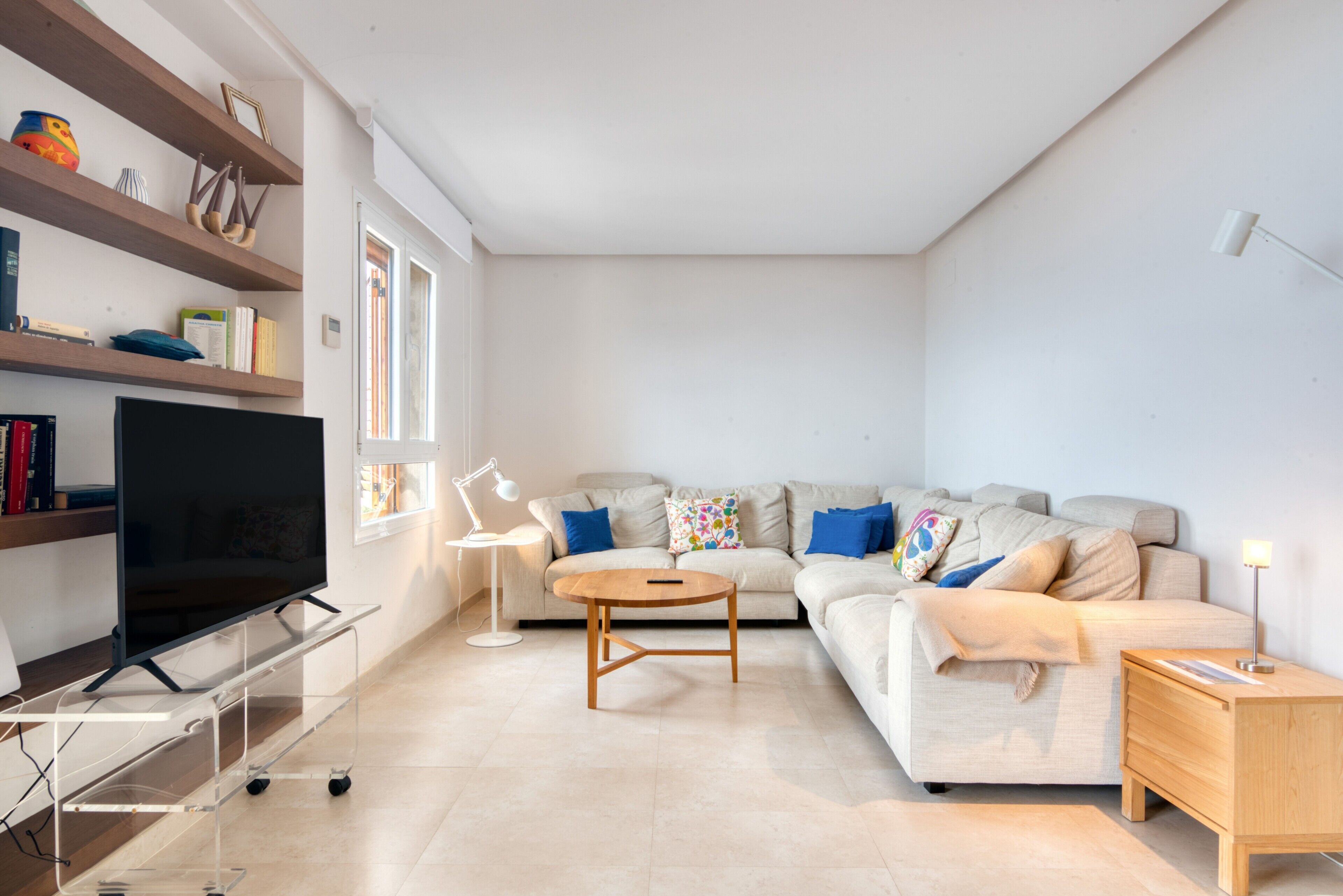 A modern living room with a sofa, TV, and a coffee table.