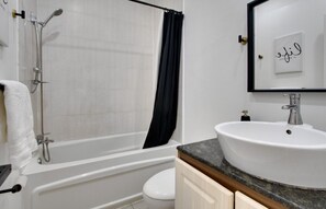 Een haardroger, handdoeken, zeep, toiletpapier