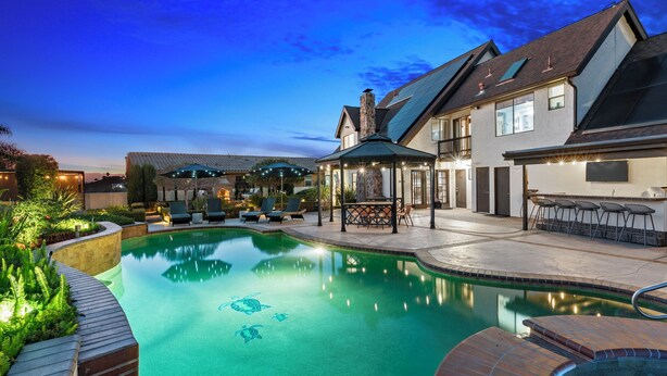 A swimming pool with a clear blue water feature, surrounded by a patio area with lounge chairs and a gazebo. - Surreal Serenity Escape wIth Game Room, Pool & Spa (La Mesa)