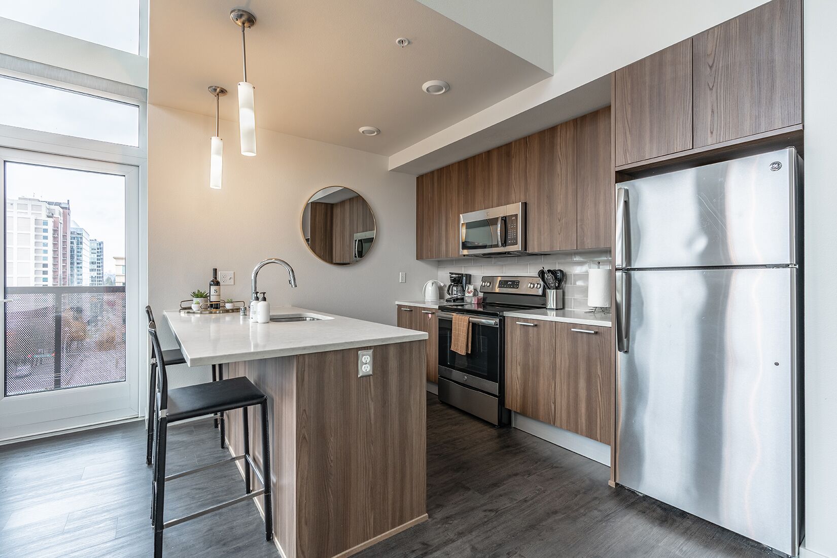 A modern kitchen with wooden cabinets, stainless steel appliances, and a large island with a sink.